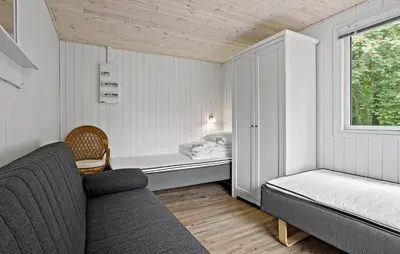 a room with a couch and a bed and a window at 3 Bedroom Nice Home In Thyholm in Thyholm