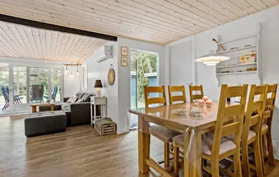 a dining room and living room with a table and chairs at 3 Bedroom Nice Home In Thyholm in Thyholm