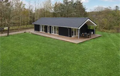 a black house with a deck in a yard at 3 Bedroom Gorgeous Home In Løgstør in Løgsted