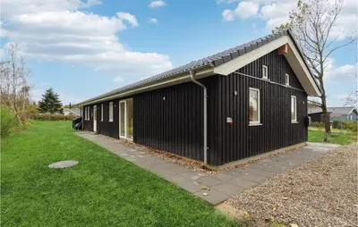 a black building with a gambrel roof at 3 Bedroom Gorgeous Home In Løgstør in Løgsted