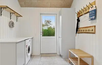 a white laundry room with a washer and dryer at 3 Bedroom Gorgeous Home In Løgstør in Løgsted