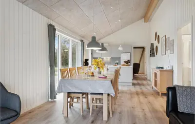 a kitchen and dining room with a table and chairs at 3 Bedroom Gorgeous Home In Løgstør in Løgsted