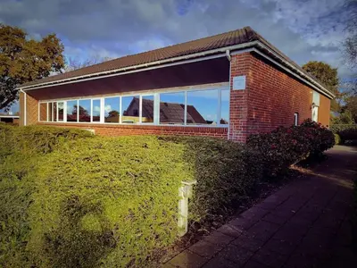 a brick building with a large group of windows at Comfortable 3- bedroom villa with free parking in Roslev