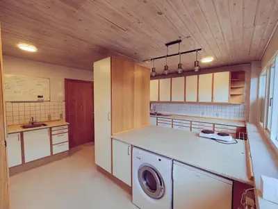 a kitchen with a washing machine in the middle at Comfortable 3- bedroom villa with free parking in Roslev