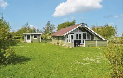 a small house in a field with a yard at Nice Home In Vinderup With Kitchen in Vinderup
