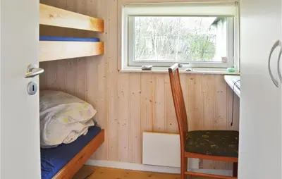 a tiny house with a bed and a window at Nice Home In Vinderup With Kitchen in Vinderup