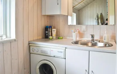 a kitchen with a washing machine and a sink at Nice Home In Vinderup With Kitchen in Vinderup
