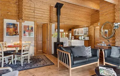 a living room with a couch and a table at Holiday Home Blokhus 59 in Blokhus