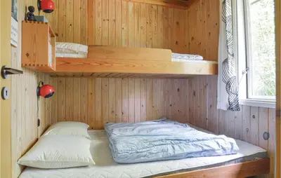 a room with two bunk beds in a cabin at Holiday Home Farsø 49 in Farsø