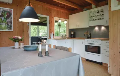 a kitchen with a table with a table cloth on it at Holiday Home Farsø 49 in Farsø