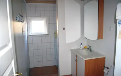 a small bathroom with a sink and a shower at Holiday Home Løgstør 53 in Løgstør