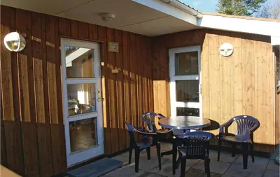a patio with a table and chairs on a house at Holiday Home Løgstør 53 in Løgstør
