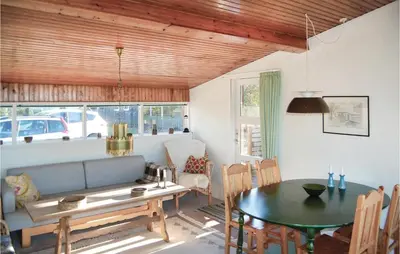 a living room with a table and a couch at Holiday Home Løgstør 53 in Løgstør