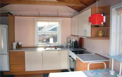 a small kitchen with a sink and a window at Holiday Home Løgstør 53 in Løgstør