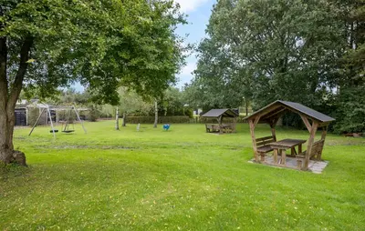 a park with a playground with a bench and a swing at Amazing Home In Farsø With Wifi in Farsø