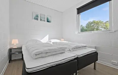 a white bedroom with a large bed with a window at Amazing Home In Farsø With Wifi in Farsø