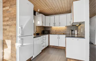 a kitchen with white cabinets and a wooden ceiling at Amazing Home In Farsø With Wifi in Farsø