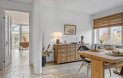 a dining room with a table and a dresser at 2 Bedroom Awesome Home In Vestervig in Vestervig