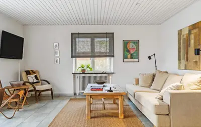 a living room with a couch and a table at 2 Bedroom Awesome Home In Vestervig in Vestervig