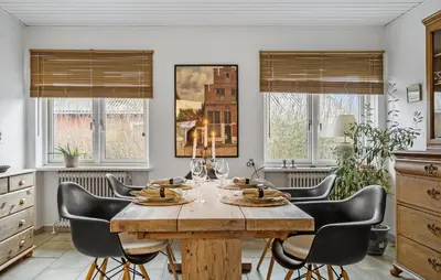 a dining room with a wooden table and chairs at 2 Bedroom Awesome Home In Vestervig in Vestervig