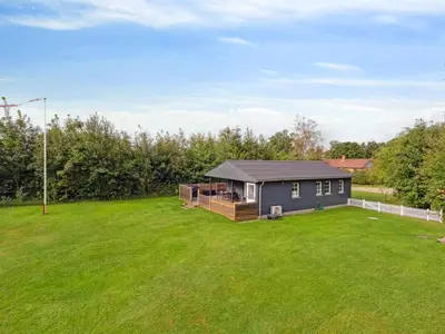 a home with a large yard with a house at Holiday Home Jobst - 600m to the fjord by Interhome in Roslev