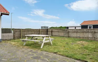 a picnic table in front of a wooden fence at 3 Bedroom Pet Friendly Home In Ulfborg in Ulfborg