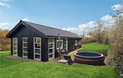 a black shed with a pool in the yard at Cozy Home In Struer With Wifi in Struer