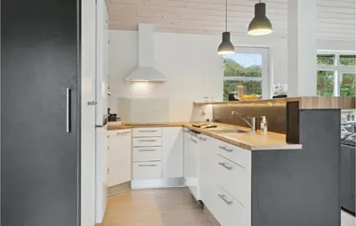 a kitchen with white cabinets and a sink at Cozy Home In Struer With Wifi in Struer