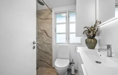 a white bathroom with a toilet and a sink at Cozy Home In Løgstrup With Wifi in Løgstrup