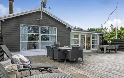 a patio with a table and chairs on a deck at Cozy Home In Løgstrup With Wifi in Løgstrup