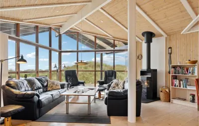 a living room with couches and a fireplace at Beautiful Home In Saltum in Saltum