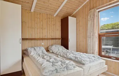 a large bed in a room with a window at Beautiful Home In Saltum in Saltum