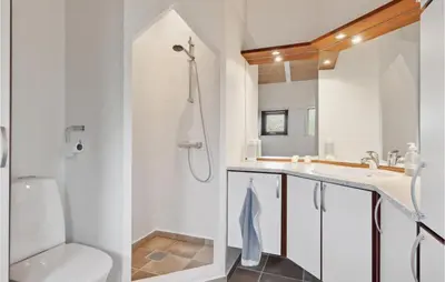 a bathroom with a toilet and a sink and a shower at Beautiful Home In Saltum in Saltum