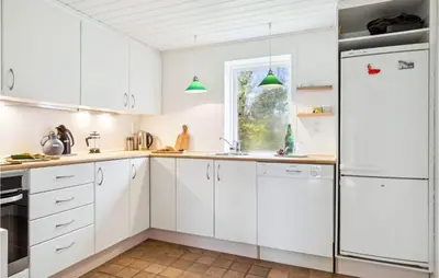 a white kitchen with white cabinets and a window at 2 Bedroom Cozy Home In Fjerritslev in Fjerritslev