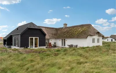a black and white house on top of a hill at 3 Bedroom Stunning Home In Lemvig in Lemvig