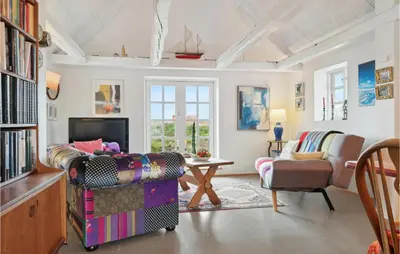 a living room with a couch and a tv at 3 Bedroom Stunning Home In Lemvig in Lemvig