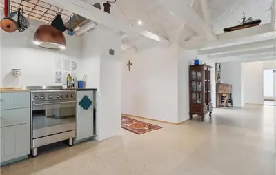 a kitchen with a stove and a cross on the wall at 3 Bedroom Stunning Home In Lemvig in Lemvig