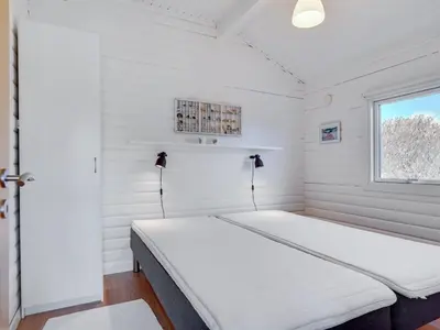 a bed in a room with a window at Holiday Home Efra - 400m from the sea by Interhome in Saltum