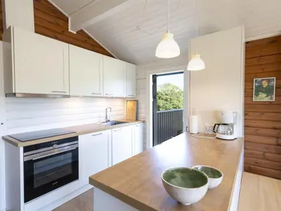 a kitchen with white cabinets and a bowl on a counter at Holiday Home Efra - 400m from the sea by Interhome in Saltum