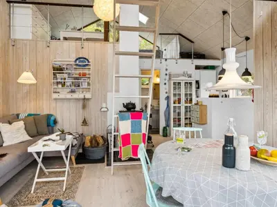 a room with a bed and a living room at Holiday Home Benni - 75m to the fjord by Interhome in Løgstør