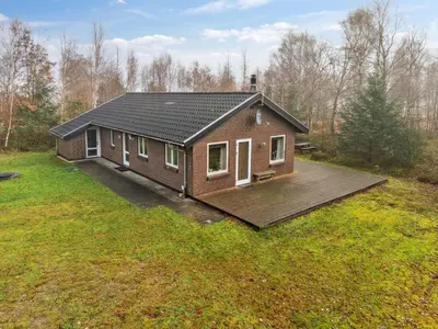 a small house with a deck in a field at Holiday Home Patrik - 200m to the fjord by Interhome in Fur