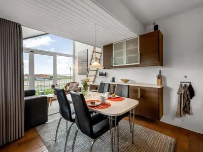 a kitchen and living room with a table and chairs at Apartment Alvy - 100m to the fjord by Interhome in Lemvig