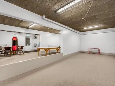 a room with a ping pong table and chairs at Apartment Alvy - 100m to the fjord by Interhome in Lemvig
