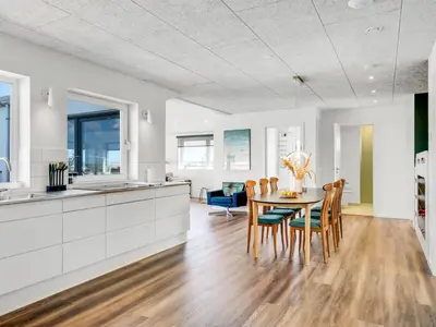 a kitchen and dining room with a table and chairs at Holiday Home Unge - 75m from the sea by Interhome in Torsted