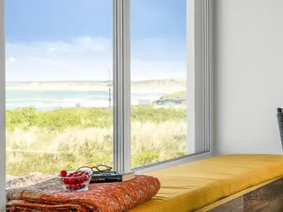 a window with a bowl of cherries on a cushion in front of it at Holiday Home Unge - 75m from the sea by Interhome in Torsted