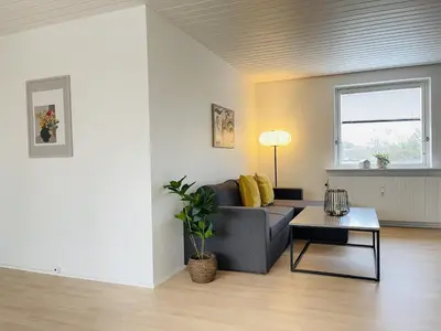 a living room with a couch and a table at aday - Modern 3 bedrooms apartment in Svenstrup in Svenstrup