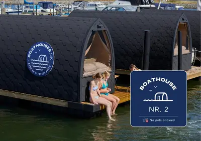 a group of girls sitting on a tiny house in the water at Boathouses dk - Besøg os direkte på hjemmesiden in Vinderup