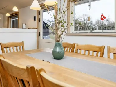 a wooden table with a vase on top of it at 4 star holiday home in Blokhus-By Traum in Blokhus