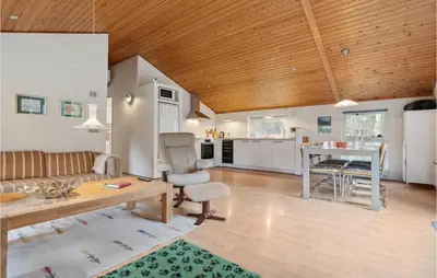 a living room with a couch and a table at Lovely Home In Hurup Thy With Wifi in Sønder Ydby