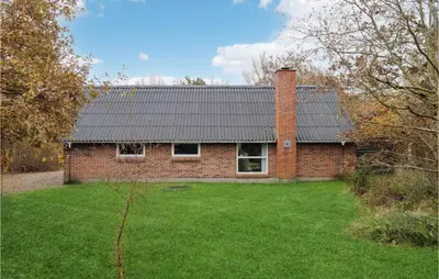 a brick house with a brick chimney and a yard at Lovely Home In Hurup Thy With Wifi in Sønder Ydby